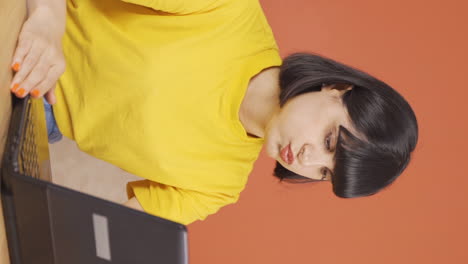 Vertical-video-of-The-young-woman-who-can't-use-the-application-on-the-laptop.